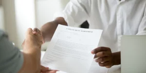 african-american-employer-holding-employment-agreement-handshaking-candidate-close-up-view_1163-3908